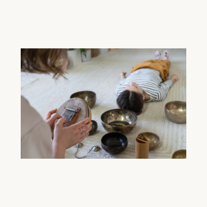 Sound Healer Holding Thumb Instrument Over Client During Session - SBB 